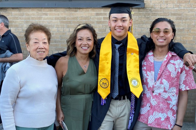 Two women and two young men at a high school graduation. 